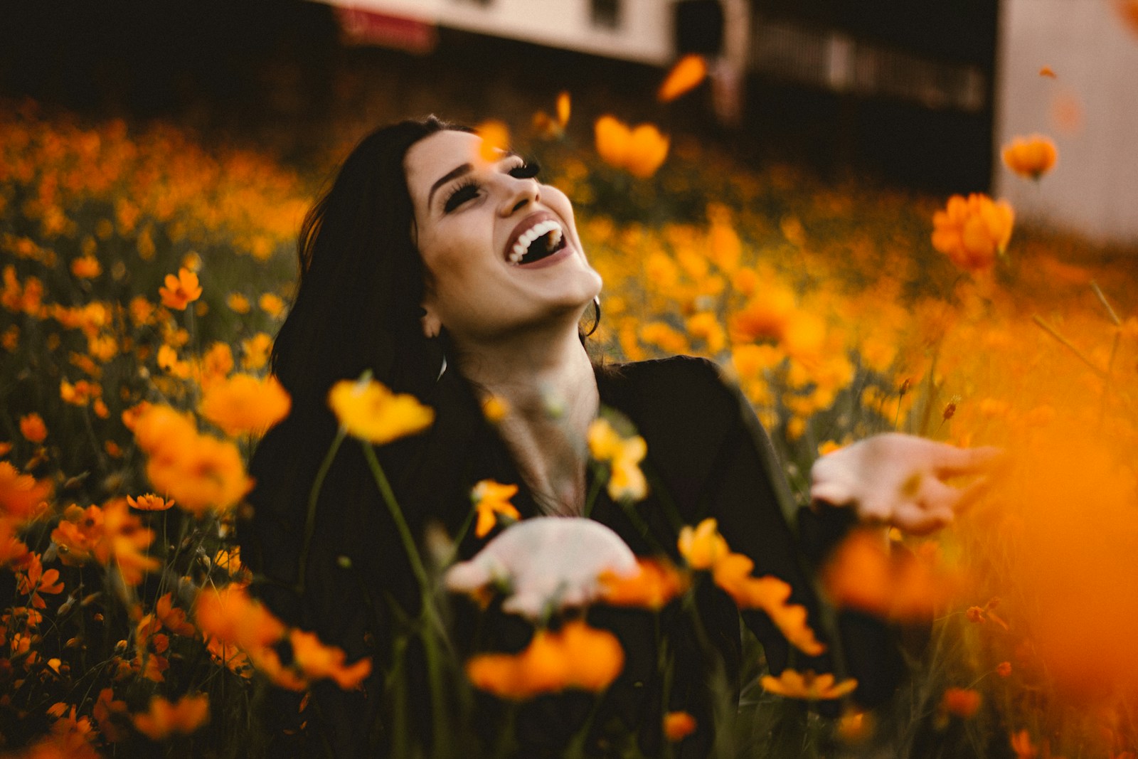 Photo by Allef Vinicius woman laughing on flower field